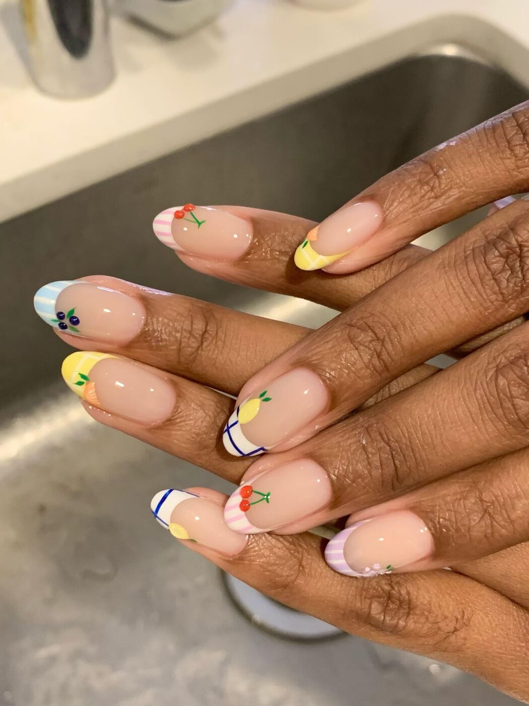 Pastel French tips with fruit art at KK Nail Studio, Long Island City nail salon